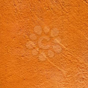 Orange painted texture. Orange colored background. Close-up of bright orange painted old textured wall.