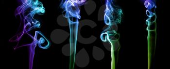 Set of abstract bright colored smoke on a dark background