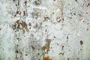 Background of old peeling paint with cracks and rust. Old weathered peeling paint texture.