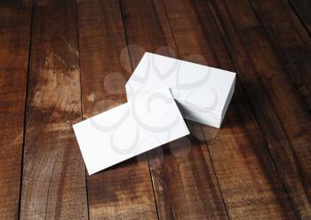 Blank white business cards on vintage wooden table background. Template for branding identity.