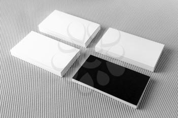 Photo of blank black and white business cards with soft shadows on gray background. Template for branding identity. For design presentations and portfolios.