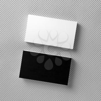 Blank black and white business cards on gray background. Mockup for branding identity for designers. Top view.
