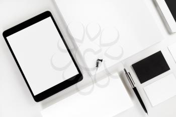 Blank corporate identity template on white paper background. Photo of blank stationery set. Mockup for design presentations and portfolios. Top view.