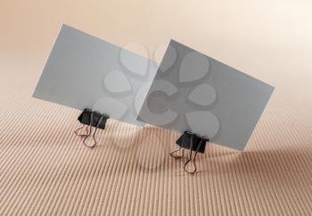 Photo of two blank business cards on a color background.