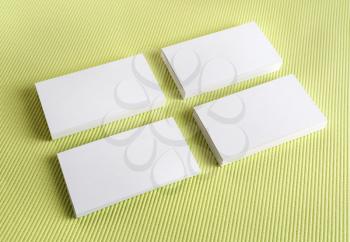 Blank white business cards on a green background. Template for branding identity.