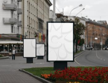 Three Blank Billboards on City Street . Clipping path.  Shallow depth of field.