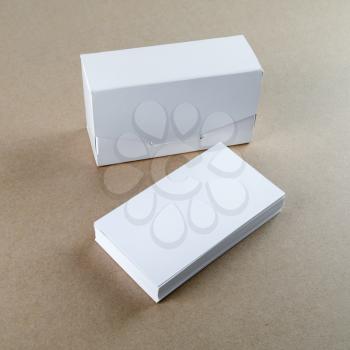 Blank business cards and a box for them on the table. Template for branding identity.