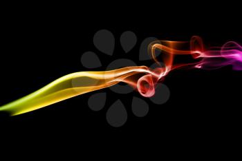 Abstract bright colored smoke on a dark background.