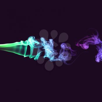 Abstract bright colored green and purple smoke on a dark background.