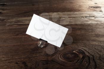Blank business card on dark wooden table background. Mock up for ID. Template for branding identity for your design.