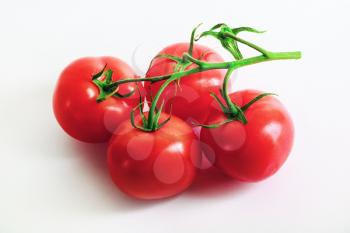 Ripe tasty fresh red tomatoes with a branch. Selective focus.