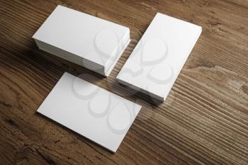 Photo of blank business cards on a wooden table background. Template for ID. Top view.