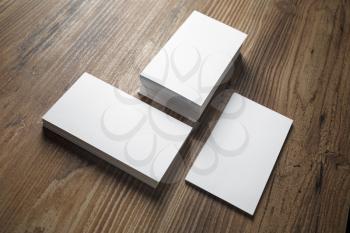 Photo of business cards on wooden office table background. Stacks of business cards. Template for branding identity.