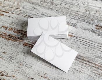 Photo of empty blank business cards on wood table background.