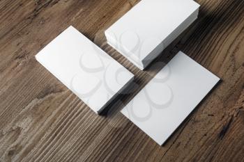Photo of blank business cards on lwood background. Mock-up for branding identity. Template for ID.