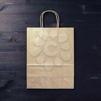 Blank brown paper bag on white background. Responsive design mockup. Flat lay.