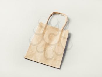 Paper shopping bag on paper background. Craft paper package.