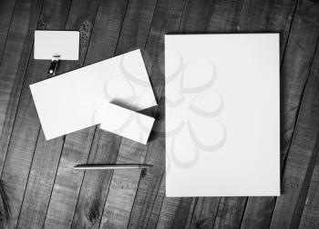Photo of blank corporate stationery template on wood background. Brand ID set. Top view.