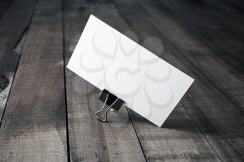 Blank white business card on wood table background. Mockup for branding identity.