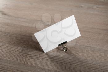 Mockup of blank business card at wood table background.