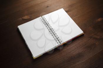 Blank notebook on wood table background. Stationery mockup. Template for placing your design.