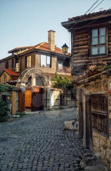Nesebar, Bulgaria - September 10, 2014: Ancient architecture: houses and stone pavement of old town Nessebar, Bulgaria. UNESCO world heritage site. Vertical shot.