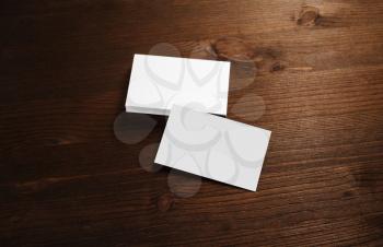 Blank white business cards on wood table background. Branding mock-up. Template for graphic designers portfolios.