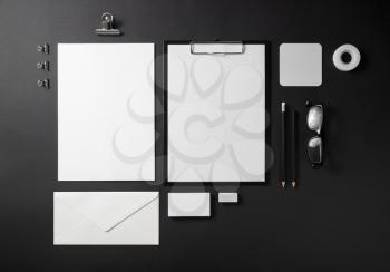 Photo of blank stationery set on black background. Corporate identity template. Responsive design mockup. Top view.