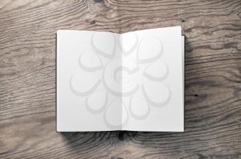 Opened blank book on wooden background. Mockup of notebook. Flat lay.