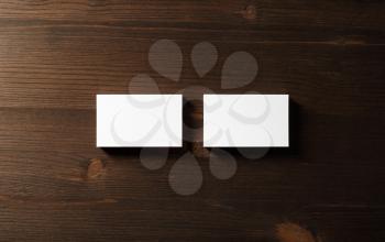 Two blank horizontal business cards on wood table background. Flat lay.