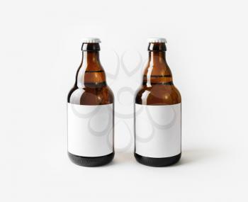 Two brown beer bottles with blank labels.