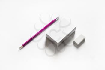 Blank business cards, pencil and eraser on paper background. Stationery template.