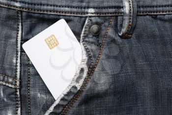 Blank white plastic chip card in jeans pocket. White credit card.