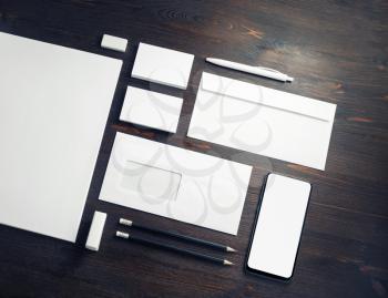 Photo of blank corporate stationery set on wooden background. Corporate ID template. Responsive design mockup.