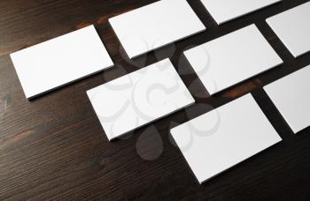 Photo of blank business cards on wood table background. Mockup for branding identity.