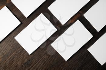 Blank white business cards on wooden background. Mockup for branding identity. Flat lay.