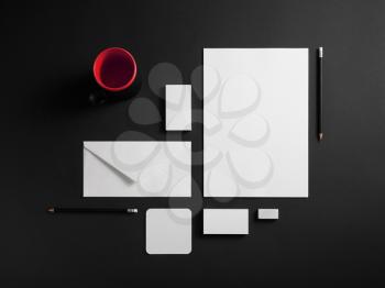 Mockup business template. Photo of blank corporate stationery set on black paper background.
