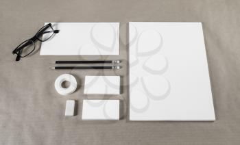Photo of blank stationery set on paper background. Paperwork template for designers. Responsive design mockup. ID template.
