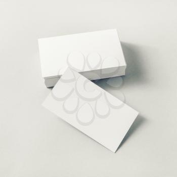 Blank white business cards on paper background.