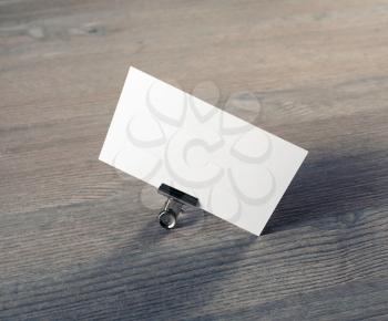 Photo of blank business card on wooden background. Mock-up for branding identity.