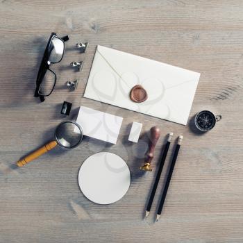 Blank envelope and stationery on wooden background. Flat lay.