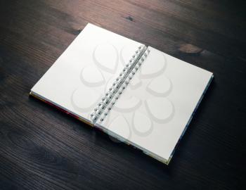 Blank notebook on wood table background. Spiral notepad. Mockup for your design.