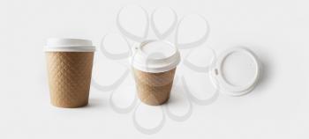 Blank take away kraft paper coffee cups with caps.