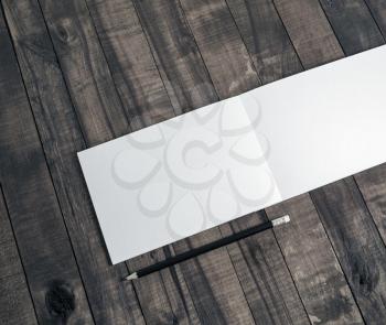 Blank notepad and pencil on wooden background. Responsive design mockup.