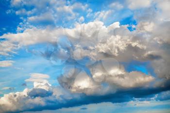 Clouds in the blue sky. Sky background with white cumulus clouds on a sunny day.