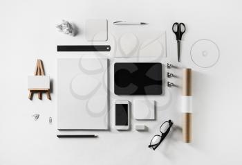 Photo of blank corporate stationery and gadgets set on white paper background. Flat lay.