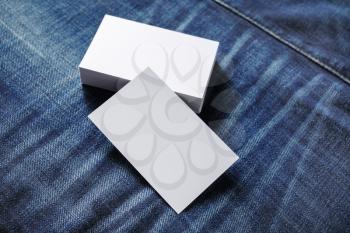 Blank business cards on denim background. Template for branding identity. Mockup for ID. Selective focus.