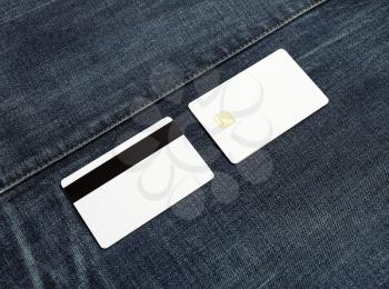 Two blank credit cards on denim background. Front and back view. Copy space for text.