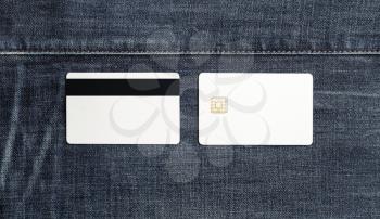 Photo of blank white bank cards on denim background. Credit cards. Front and back view. Flat lay.
