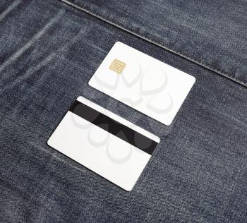 Two blank credit cards on gray denim background. Bank cards. Front and back view.